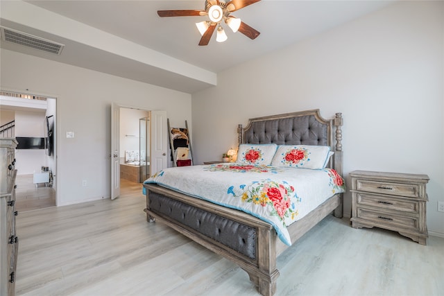 bedroom featuring ensuite bathroom, light wood-type flooring, and ceiling fan