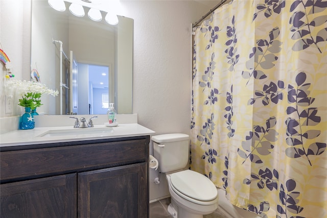 bathroom with curtained shower, vanity, and toilet