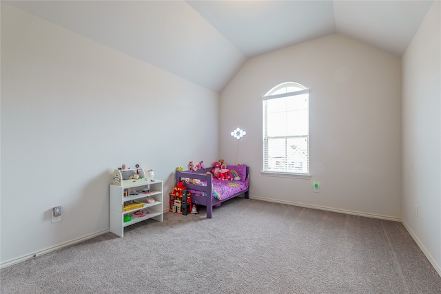 bedroom featuring carpet and vaulted ceiling