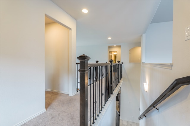 staircase featuring carpet flooring