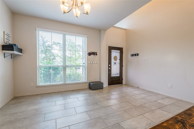 foyer with a chandelier and light tile patterned floors