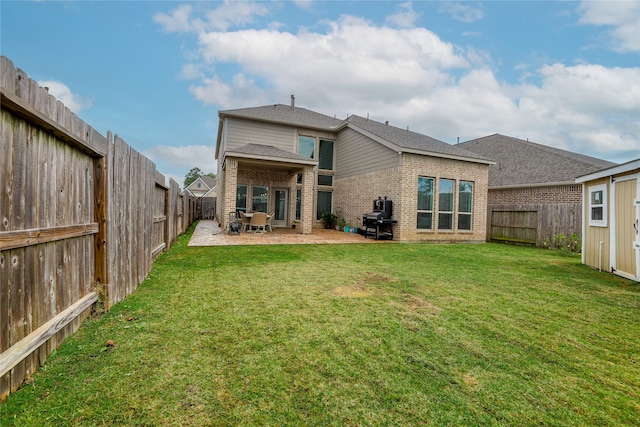 back of house featuring a patio and a yard