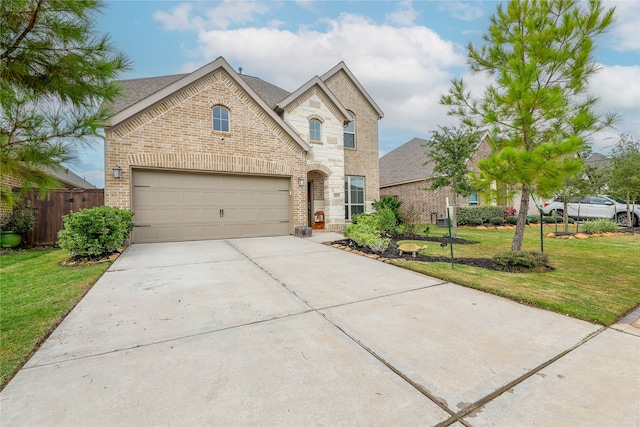 view of front of house with a garage and a front lawn