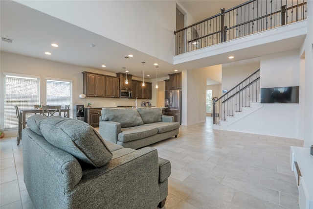 living room featuring a high ceiling