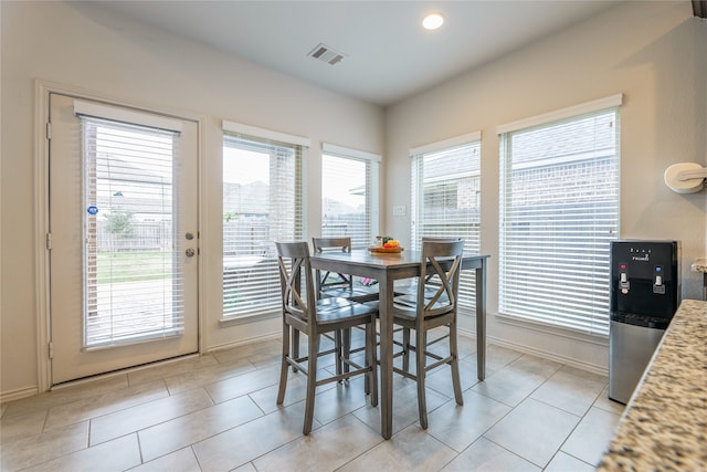 dining area with light tile patterned floors