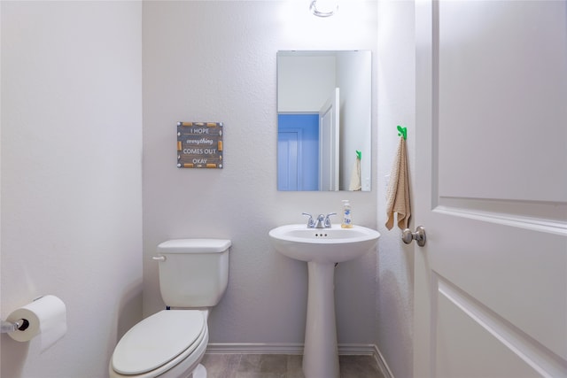 bathroom with hardwood / wood-style floors, sink, and toilet