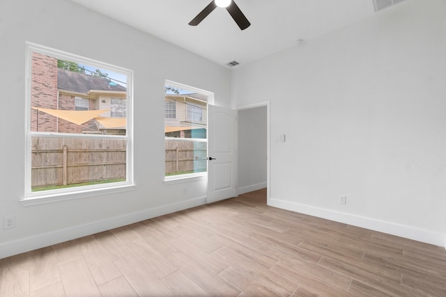 empty room featuring ceiling fan and light hardwood / wood-style floors