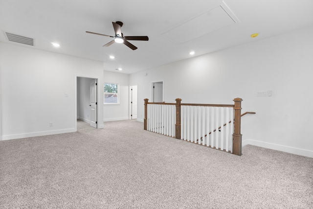 carpeted spare room with ceiling fan