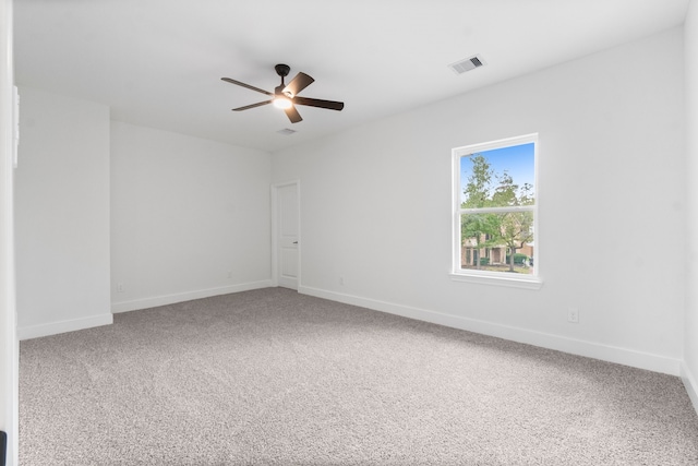 spare room with carpet floors and ceiling fan