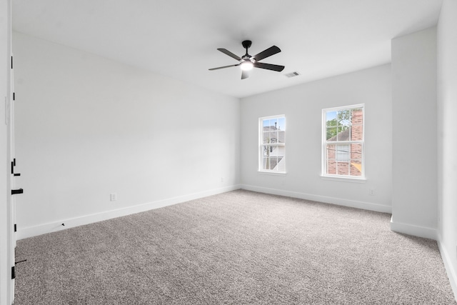 spare room with ceiling fan and carpet floors