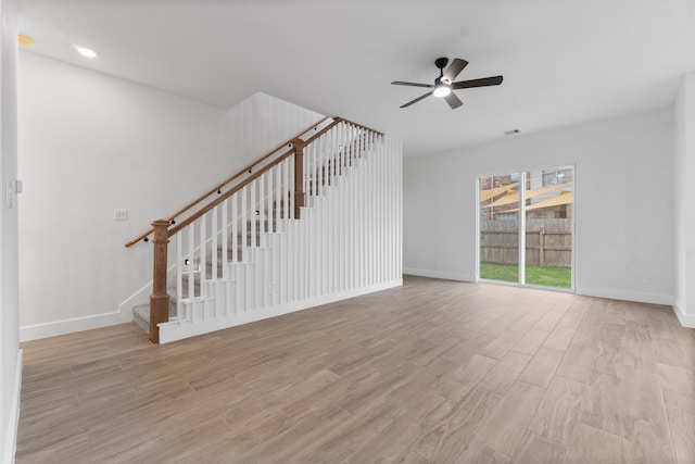 unfurnished living room with light wood-type flooring and ceiling fan