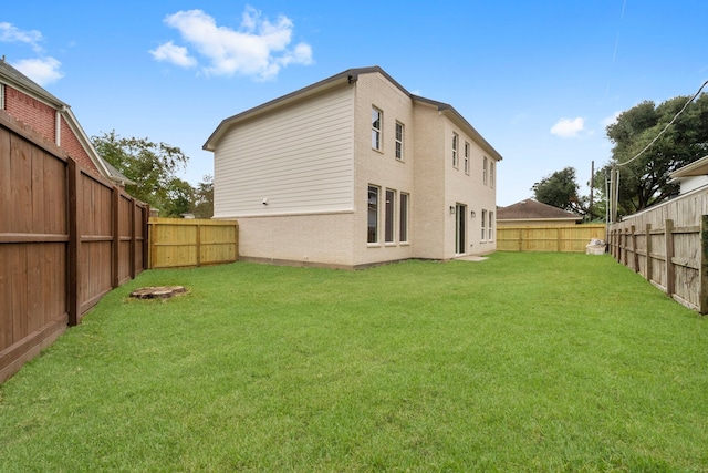 back of house with a lawn