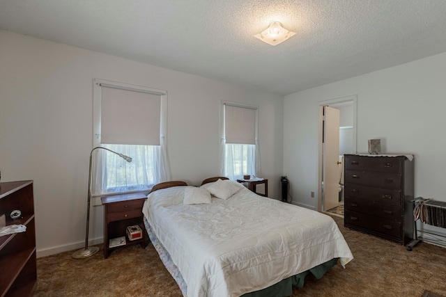 carpeted bedroom featuring a textured ceiling