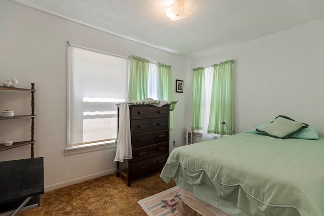 carpeted bedroom with a textured ceiling