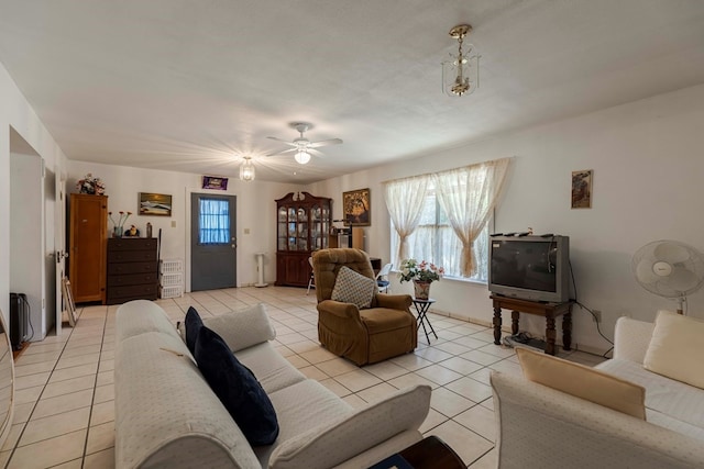 tiled living room with ceiling fan