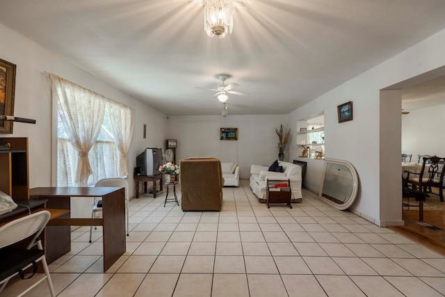 living room featuring ceiling fan and light tile patterned floors