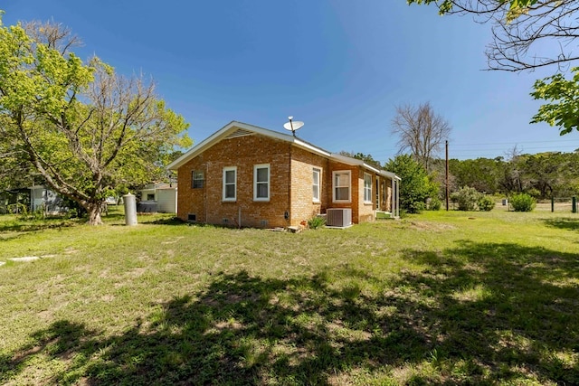 view of property exterior with central AC and a yard