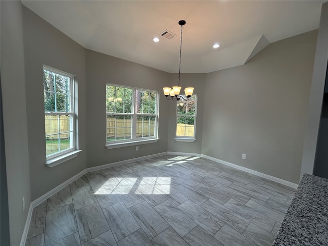 unfurnished dining area with a chandelier and a wealth of natural light