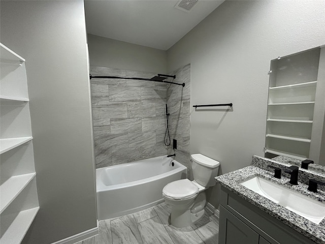 full bathroom with vanity, tiled shower / bath, and toilet