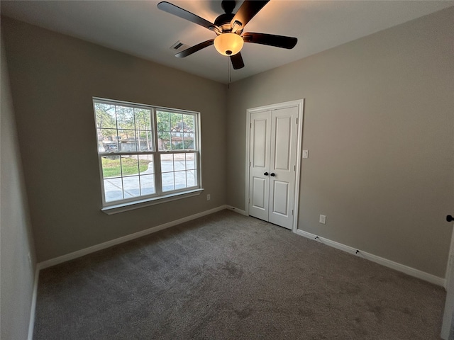 carpeted spare room with ceiling fan