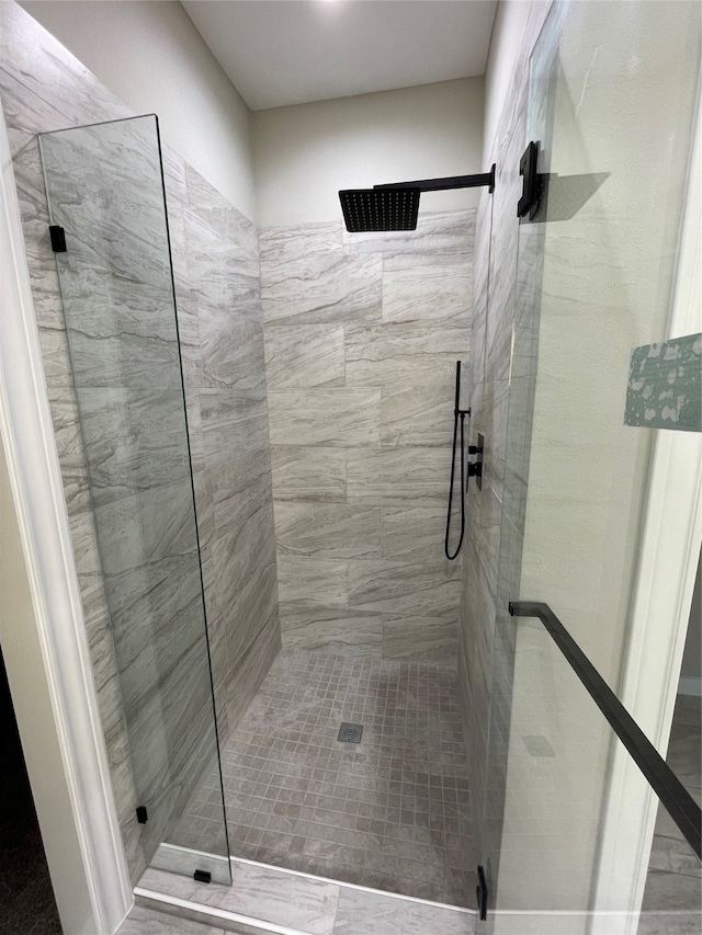 bathroom featuring a shower with shower door