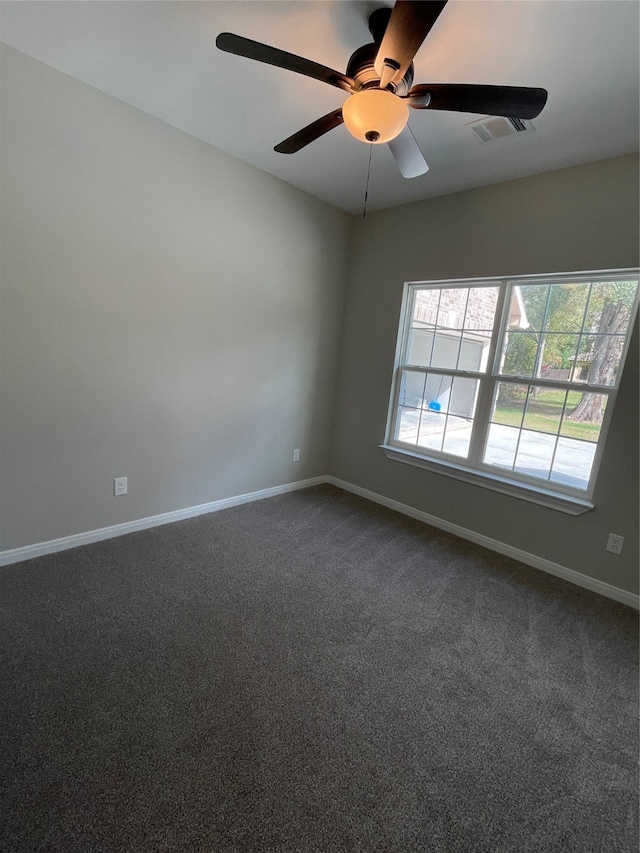 carpeted empty room featuring ceiling fan