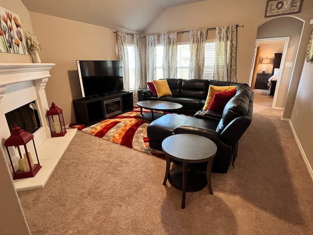 carpeted living room with vaulted ceiling