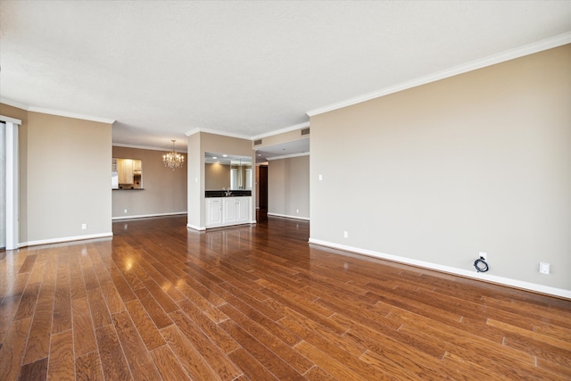 unfurnished living room featuring a chandelier, dark hardwood / wood-style floors, and crown molding