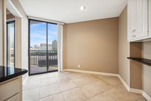 unfurnished dining area with light tile patterned flooring