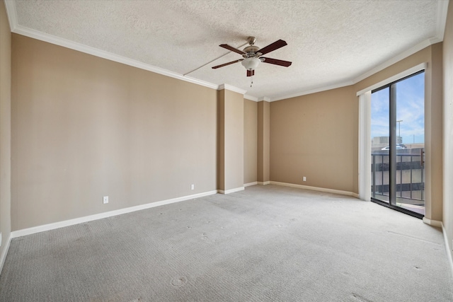 carpeted spare room with ceiling fan, a healthy amount of sunlight, a textured ceiling, and crown molding