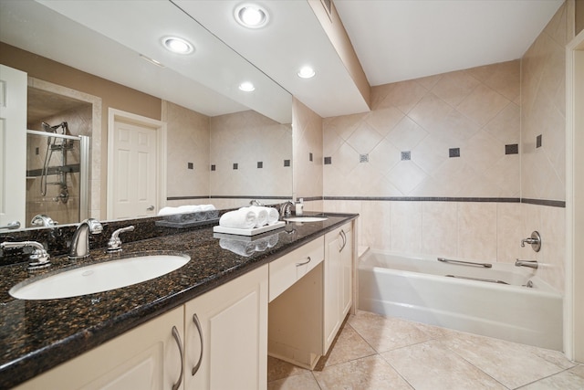 bathroom featuring tile walls, tile patterned flooring, vanity, and plus walk in shower