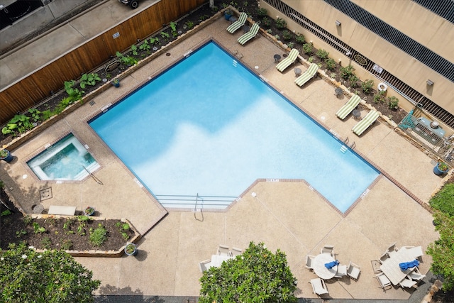 view of swimming pool with a hot tub and a patio