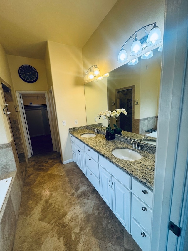 bathroom with tiled bath and vanity