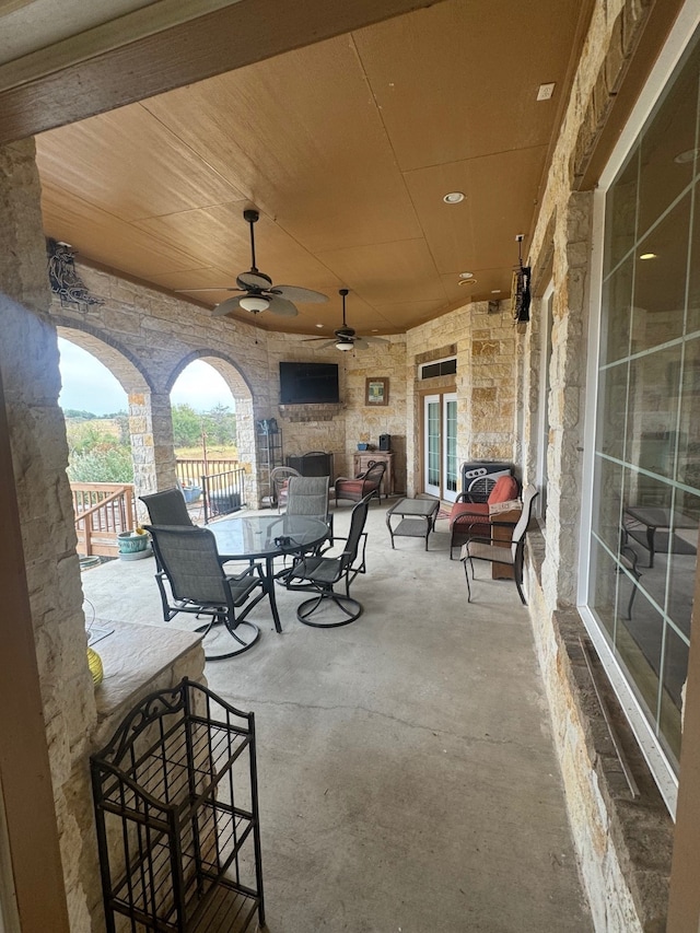 view of patio with ceiling fan and an outdoor living space