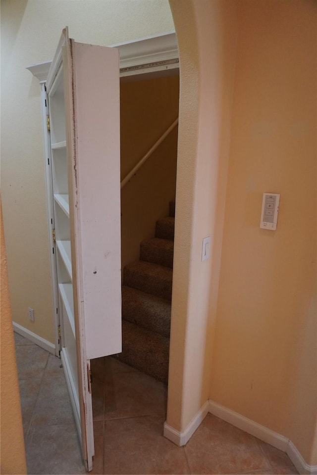6016 Fm 2720, Maxwell, TX 78656 - stairway with arched walkways, baseboards, and tile patterned floors