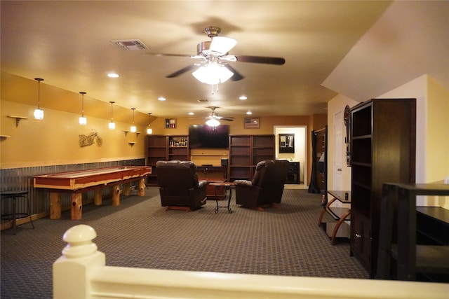 recreation room featuring ceiling fan and dark carpet