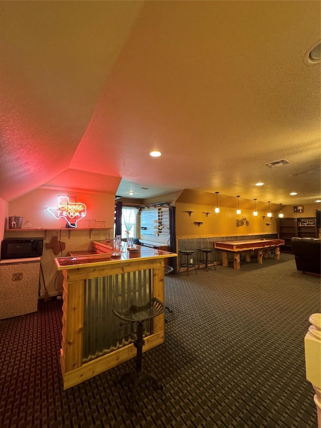 6016 Fm 2720, Maxwell, TX 78656 - playroom with carpet floors, a dry bar, a textured ceiling, billiards table, and vaulted ceiling