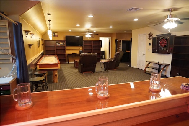 carpeted dining room with ceiling fan