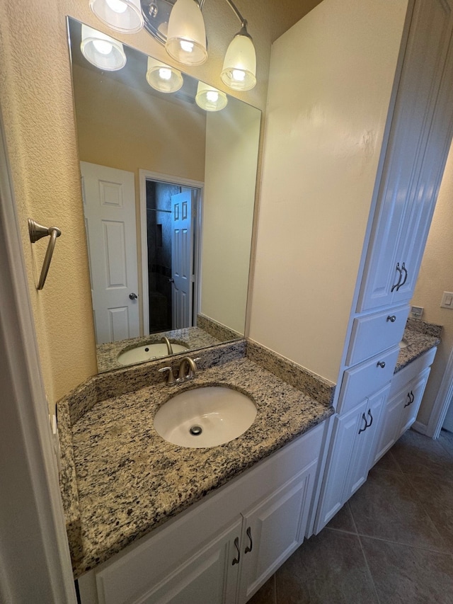 bathroom featuring tile patterned flooring and vanity