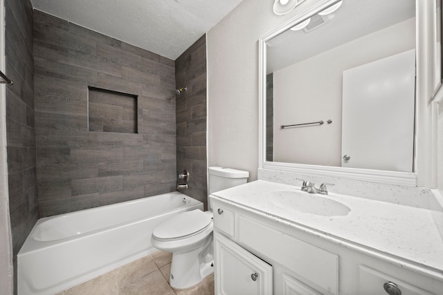 full bathroom with tile patterned flooring, a textured ceiling, vanity, toilet, and tiled shower / bath combo