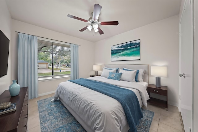 bedroom with ceiling fan and light tile patterned floors