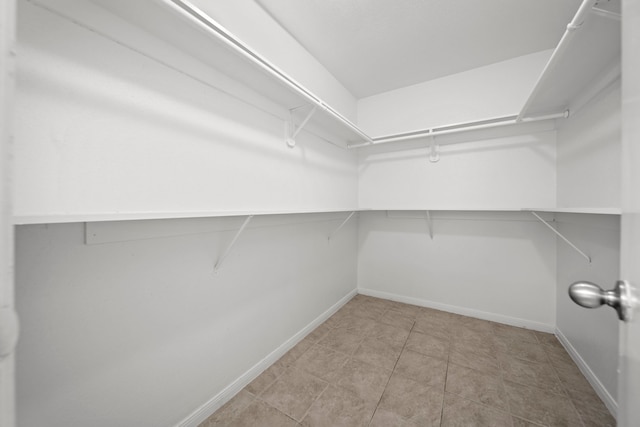 walk in closet featuring light tile patterned floors