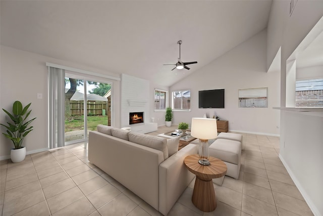 living room with high vaulted ceiling, a large fireplace, light tile patterned floors, and ceiling fan