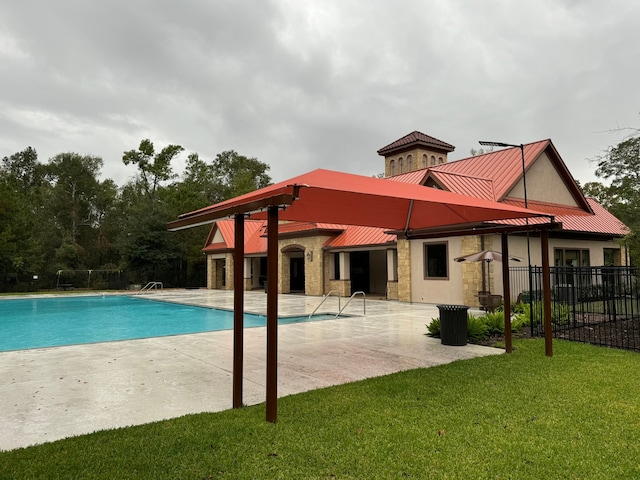 view of pool featuring a yard and a patio