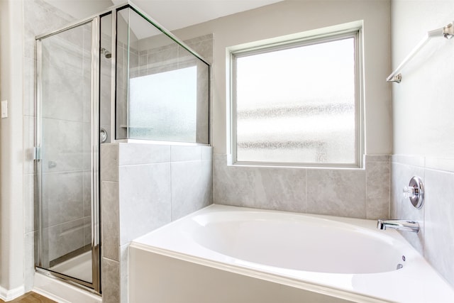 bathroom featuring independent shower and bath