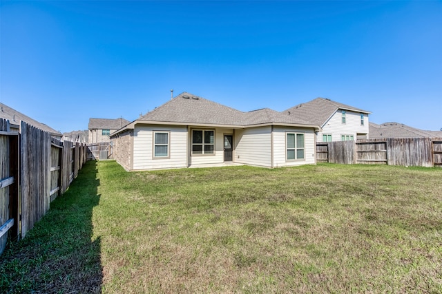 rear view of house with a yard