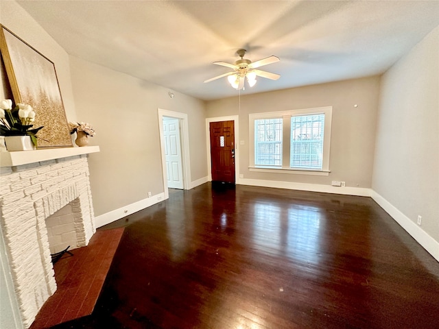 living room featuring a fireplace, ceiling fan, and dark hardwood / wood-style flooring