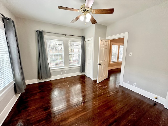 unfurnished bedroom with dark wood-type flooring and ceiling fan