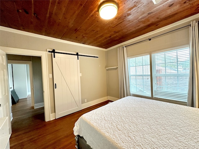 bedroom with dark wood-type flooring, a barn door, wooden ceiling, and crown molding