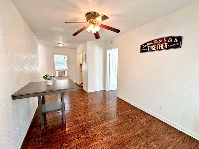 interior space featuring dark hardwood / wood-style flooring, cooling unit, a textured ceiling, and ceiling fan